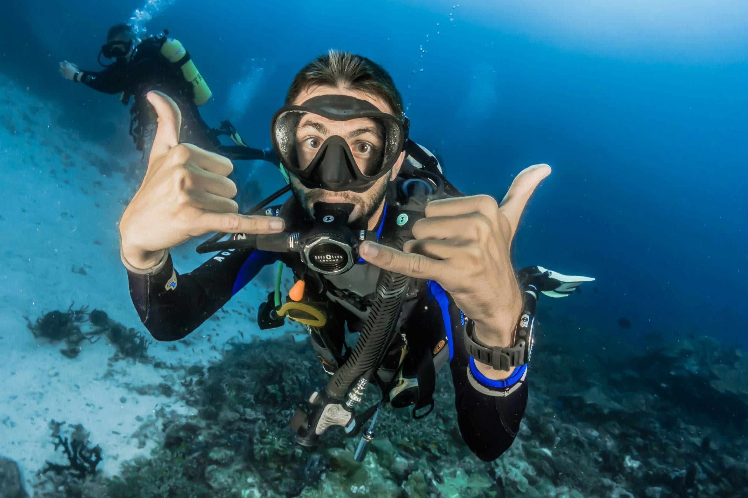 A diver signalling OK underwater on a Koh Tao dive site