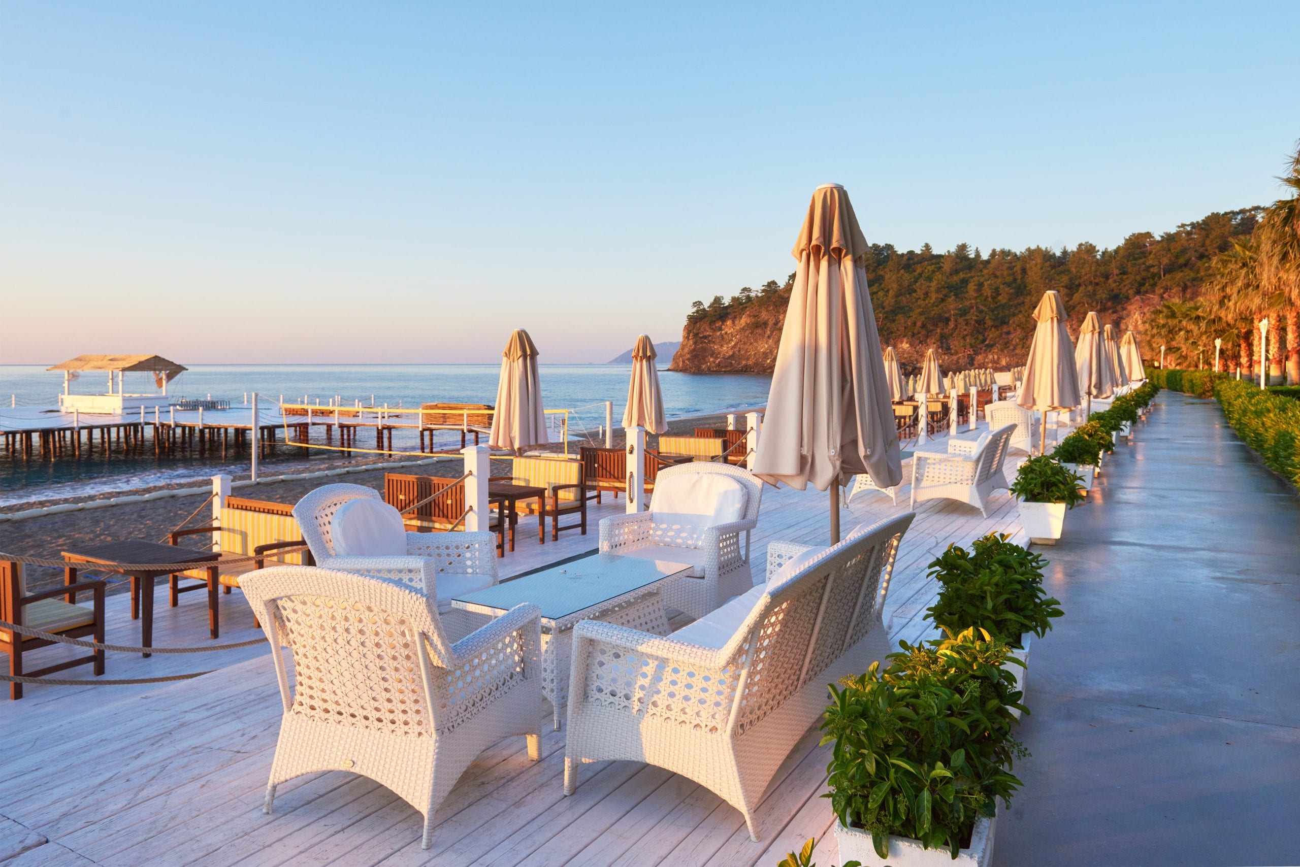 Loungers and parasols at a quieter beach club as the sun drops